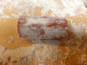 Roll hot dog in flour